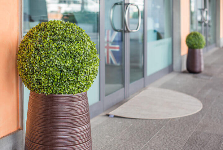 The glass door of a travel Agency. A suitcase with the British flag behind the transparent door of the office